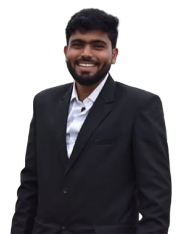 Charudatta Warke smiling, wearing a black blazer and white shirt